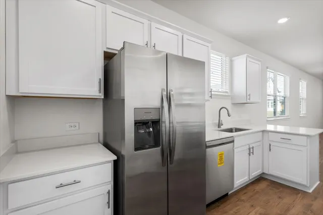 a kitchen with sink and cabinets