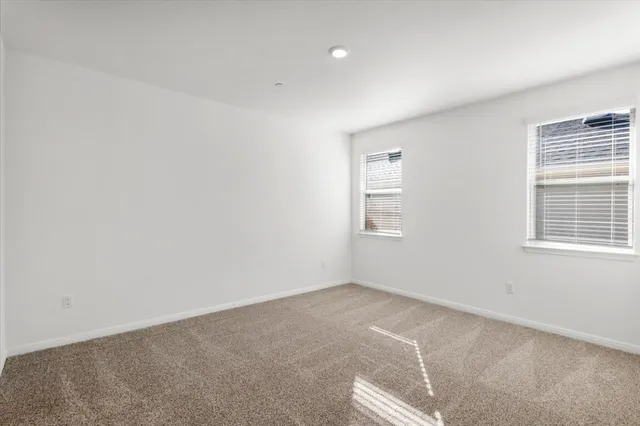 a kitchen with a sink a refrigerator and cabinets