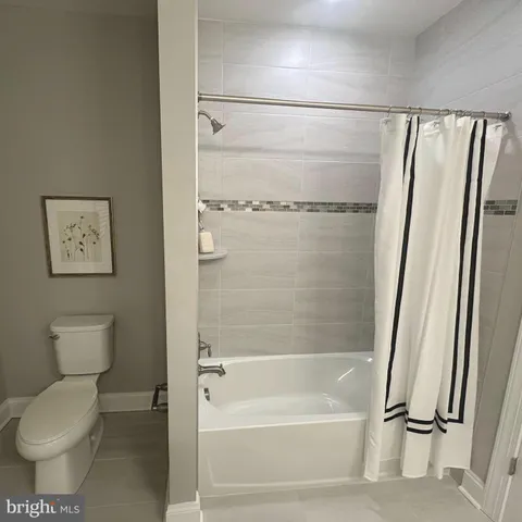 a kitchen with stainless steel appliances granite countertop a sink a stove a refrigerator with a dining table and chairs