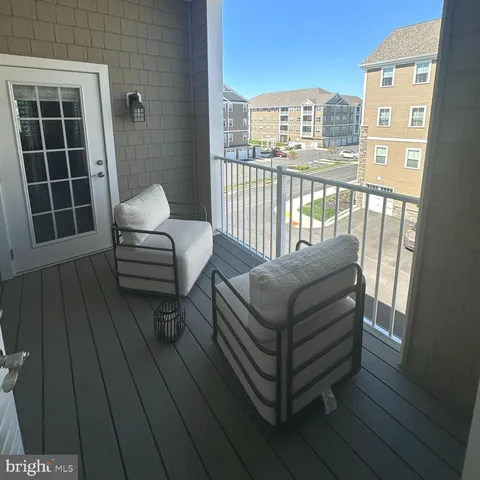 a view of a hallway with wooden floor and cabinet