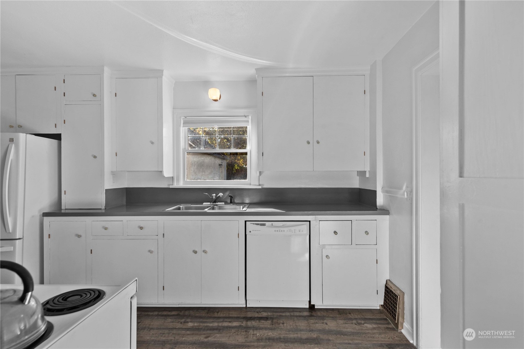 618 Hawthorne Street Wenatchee, WA 98801 - Photo 12 of 37 a kitchen with granite countertop white cabinets and sink