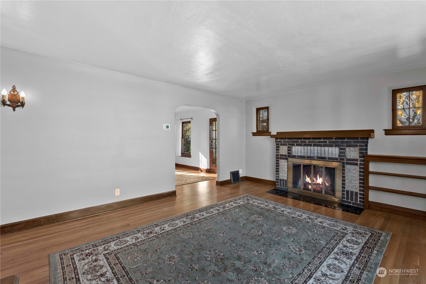 618 Hawthorne Street Wenatchee, WA 98801 - Photo 5 of 37 a view of an empty room with wooden floor fireplace and a window