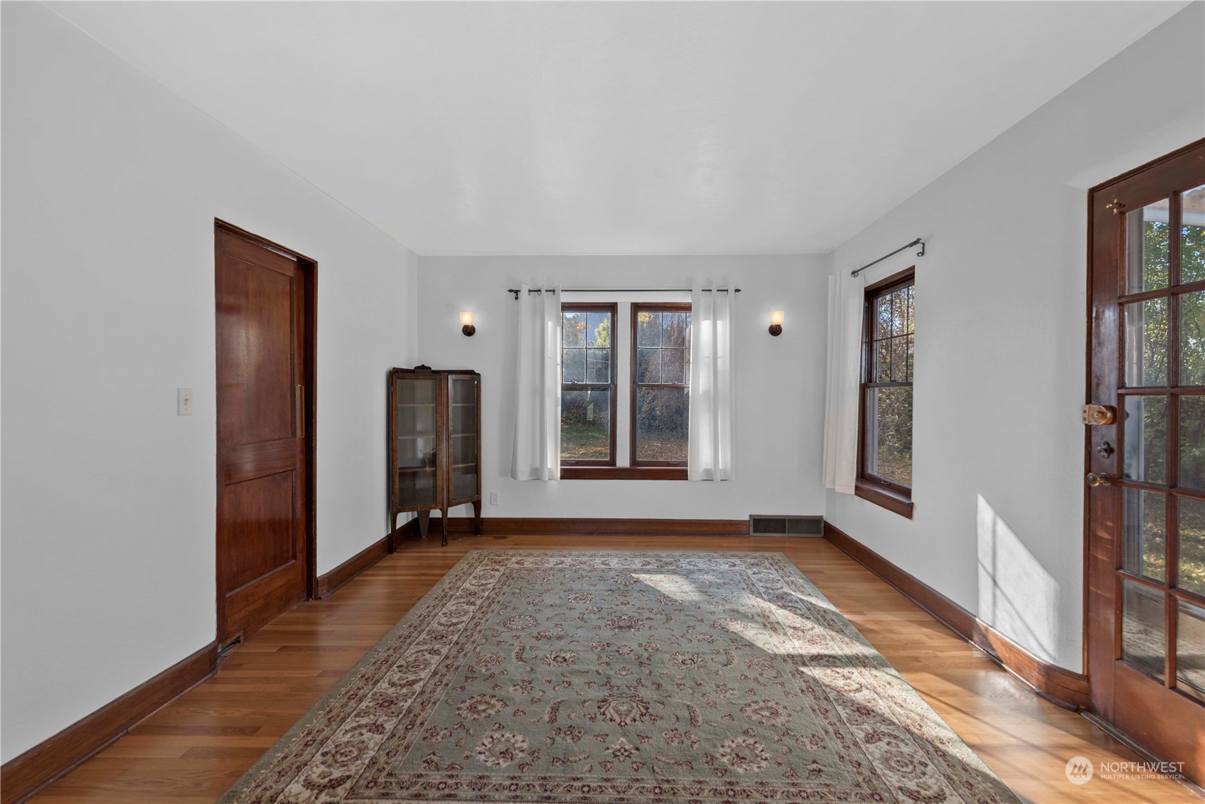 618 Hawthorne Street Wenatchee, WA 98801 - Photo 9 of 37 a view of an empty room with a window and wooden floor