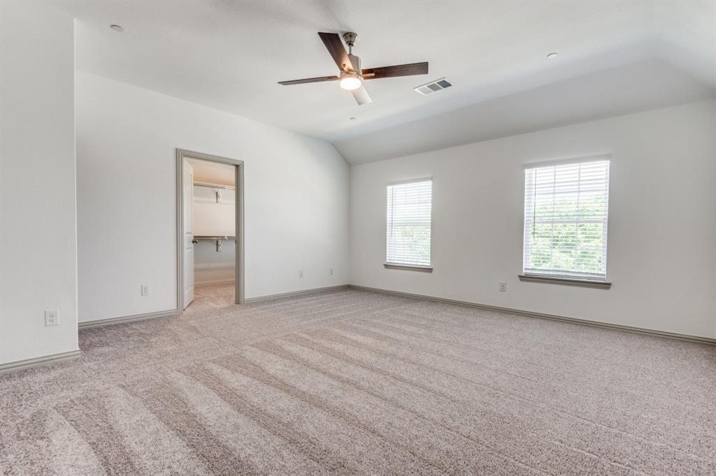 8913 Swallowtail Street Frisco, TX 75035 - Photo 25 of 38 an empty room with windows and ceiling fan