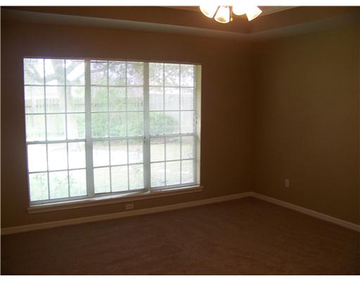 7725 Valley View Drive Corpus Christi, TX 78413 - Photo 5 of 9 an empty room with wooden floor and windows