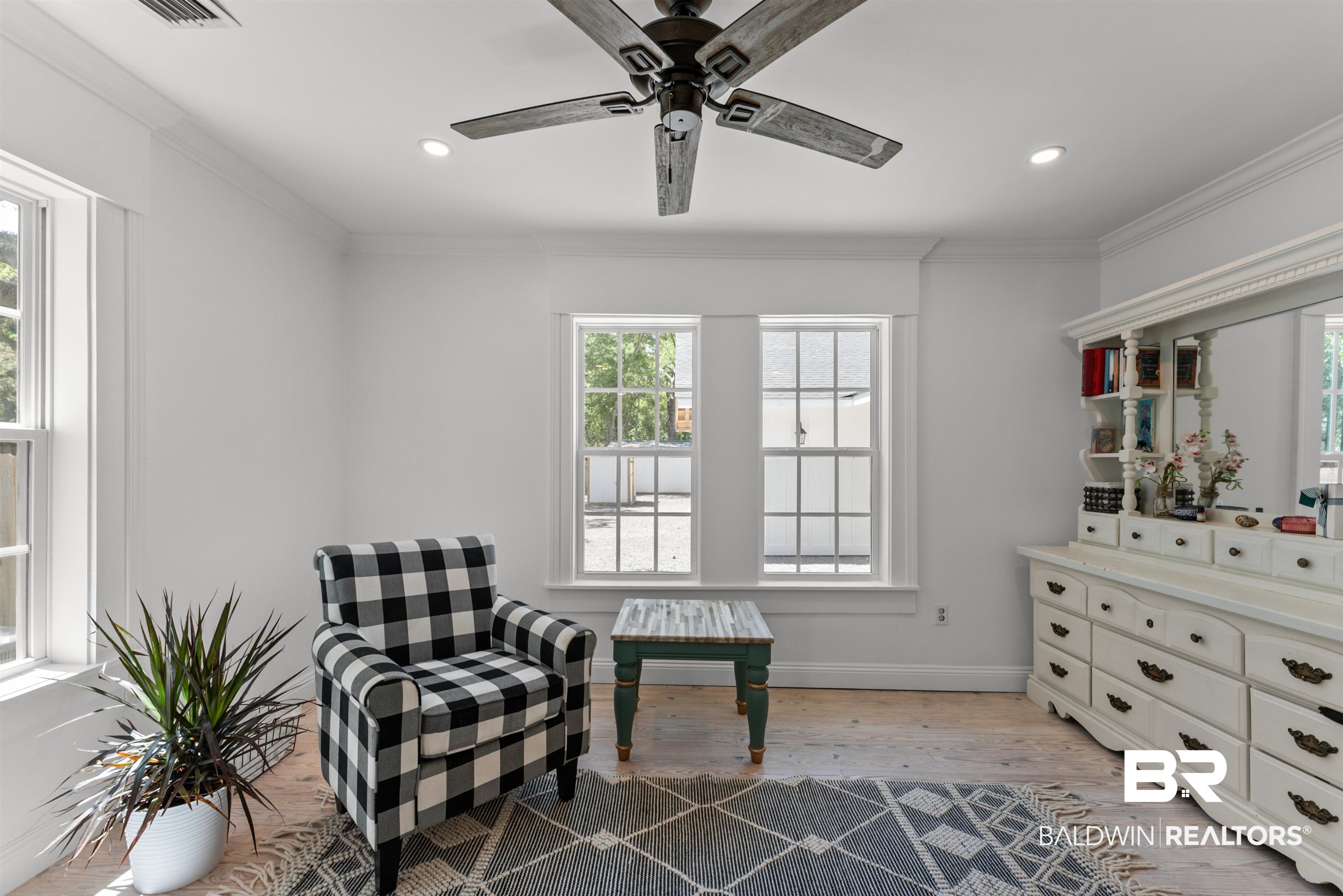 6447 Bemis Lane Bon Secour, AL 36511 - Photo 36 of 62 Bright room featuring wood-finish flooring, white walls, and crown molding