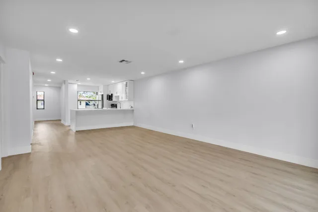 a view of a kitchen with a sink and a refrigerator
