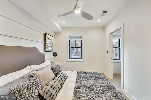 a bedroom with a bed and a window