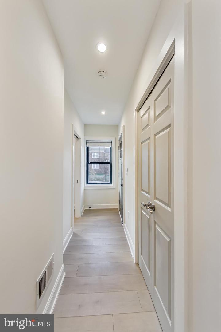 428 Evarts Street Northeast, Unit 2 Washington, DC 20017 - Photo 20 of 37 a view of a hallway with a white walls