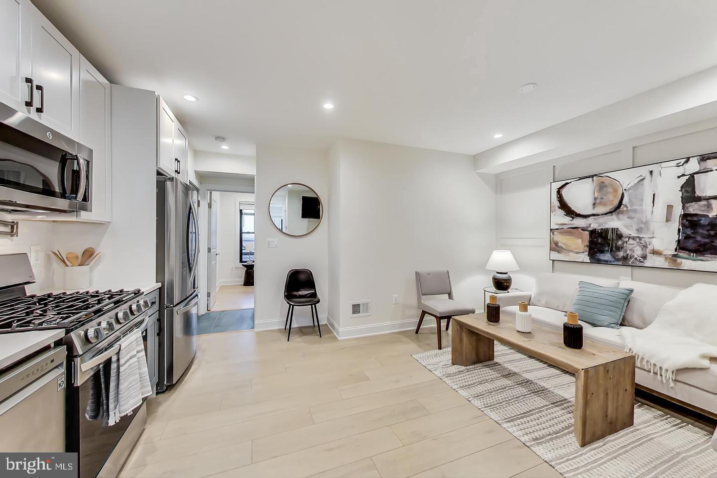 428 Evarts Street Northeast, Unit 2 Washington, DC 20017 - Photo 3 of 37 a living room with furniture and a flat screen tv