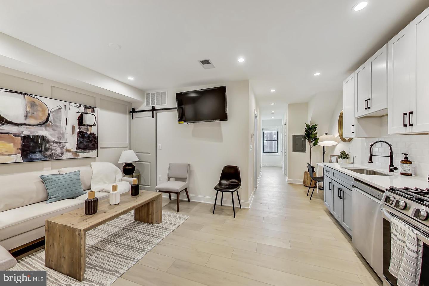 428 Evarts Street Northeast, Unit 2 Washington, DC 20017 - Photo 4 of 37 a living room with furniture and a flat screen tv
