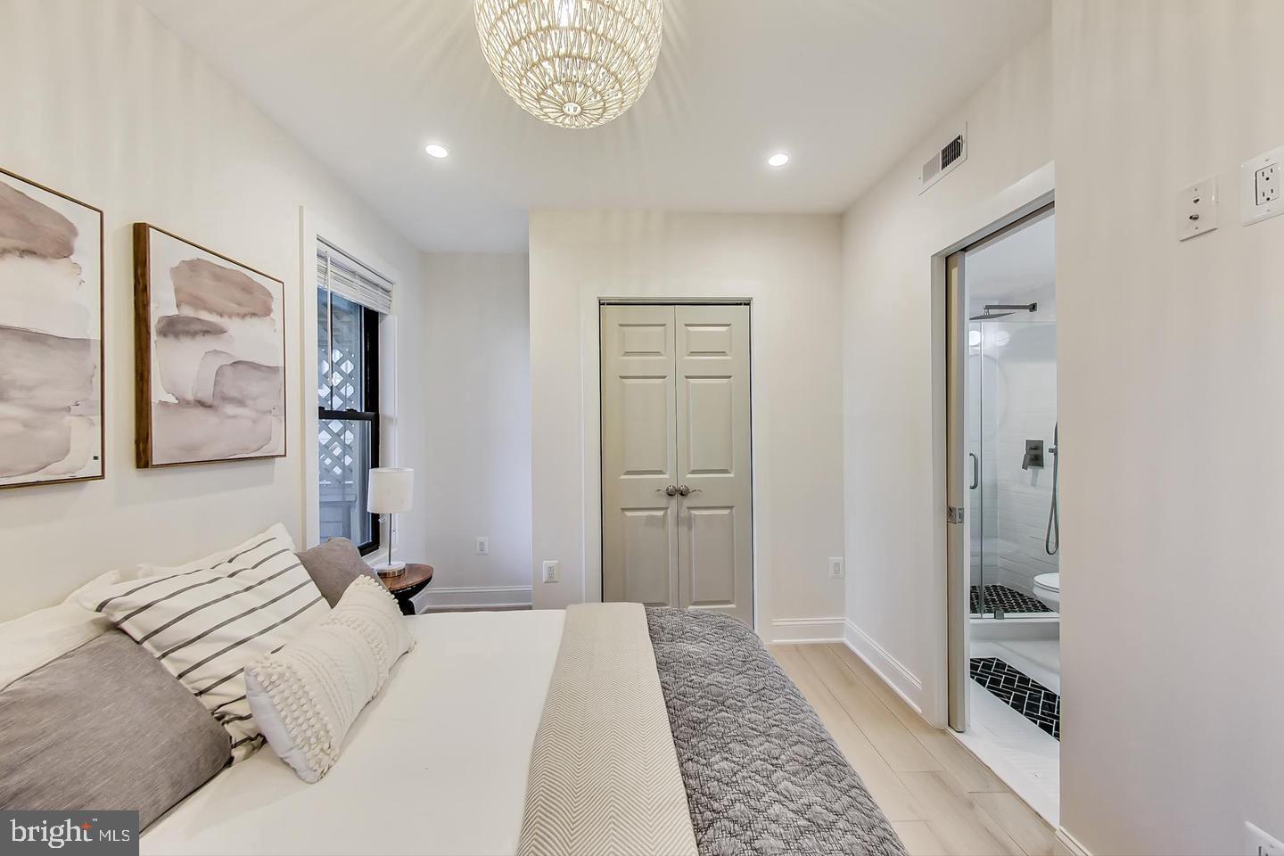 428 Evarts Street Northeast, Unit 2 Washington, DC 20017 - Photo 10 of 37 a bedroom with a bed and a walk in closet