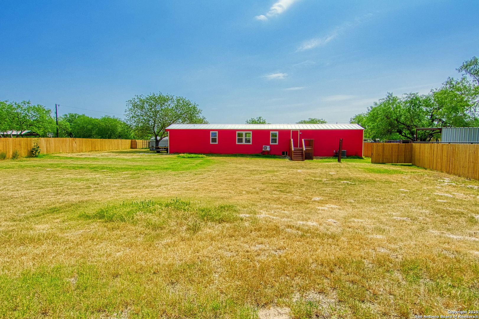 18883 La Gloria Road Elmendorf, TX 78112 - Photo 46 of 46 a view of yard with swimming pool and trees in the background