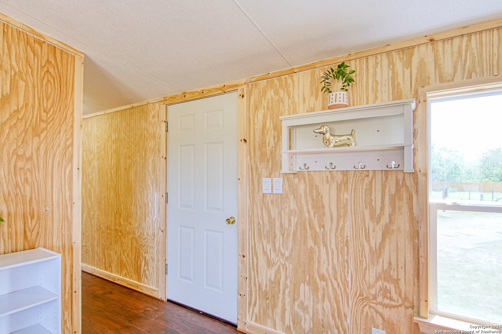 18883 La Gloria Road Elmendorf, TX 78112 - Photo 7 of 46 a view of a closet with wooden floor