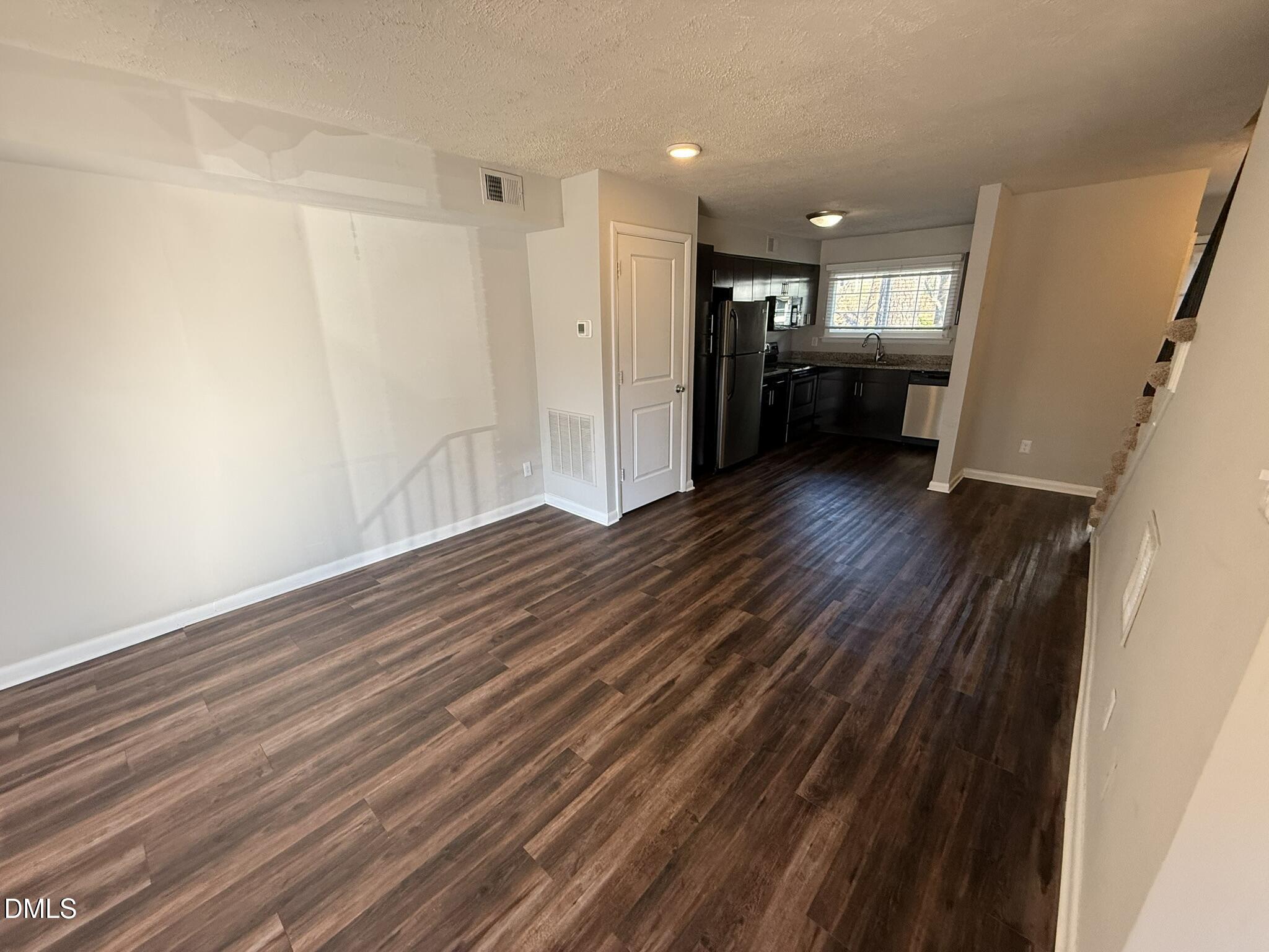 2616 Noble Road, Unit C Raleigh, NC 27608 - Photo 3 of 11 a view of empty room with wooden floor