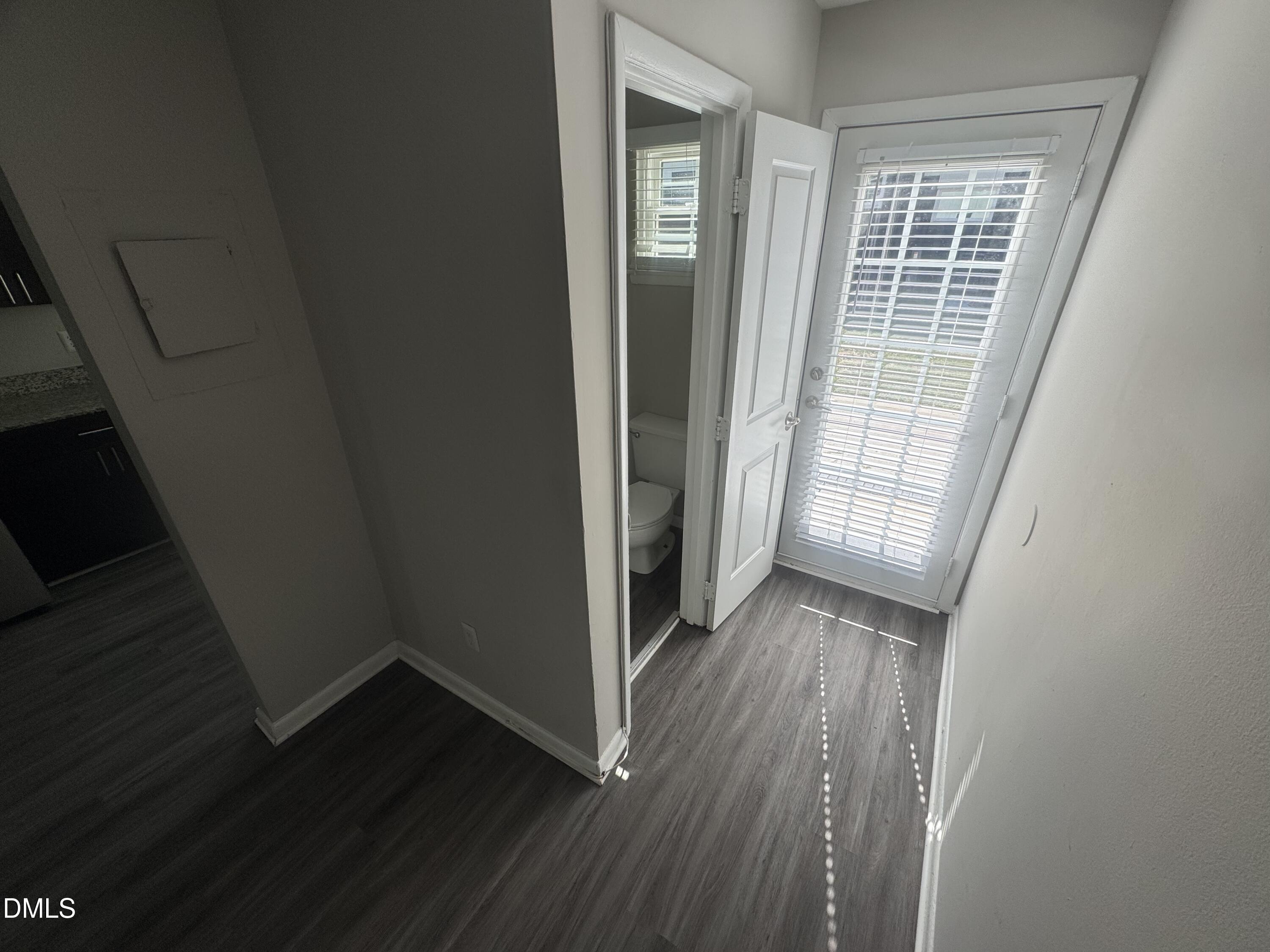 2604 Noble Road, Unit C Raleigh, NC 27608 - Photo 4 of 7 wooden floor in an empty room with a window