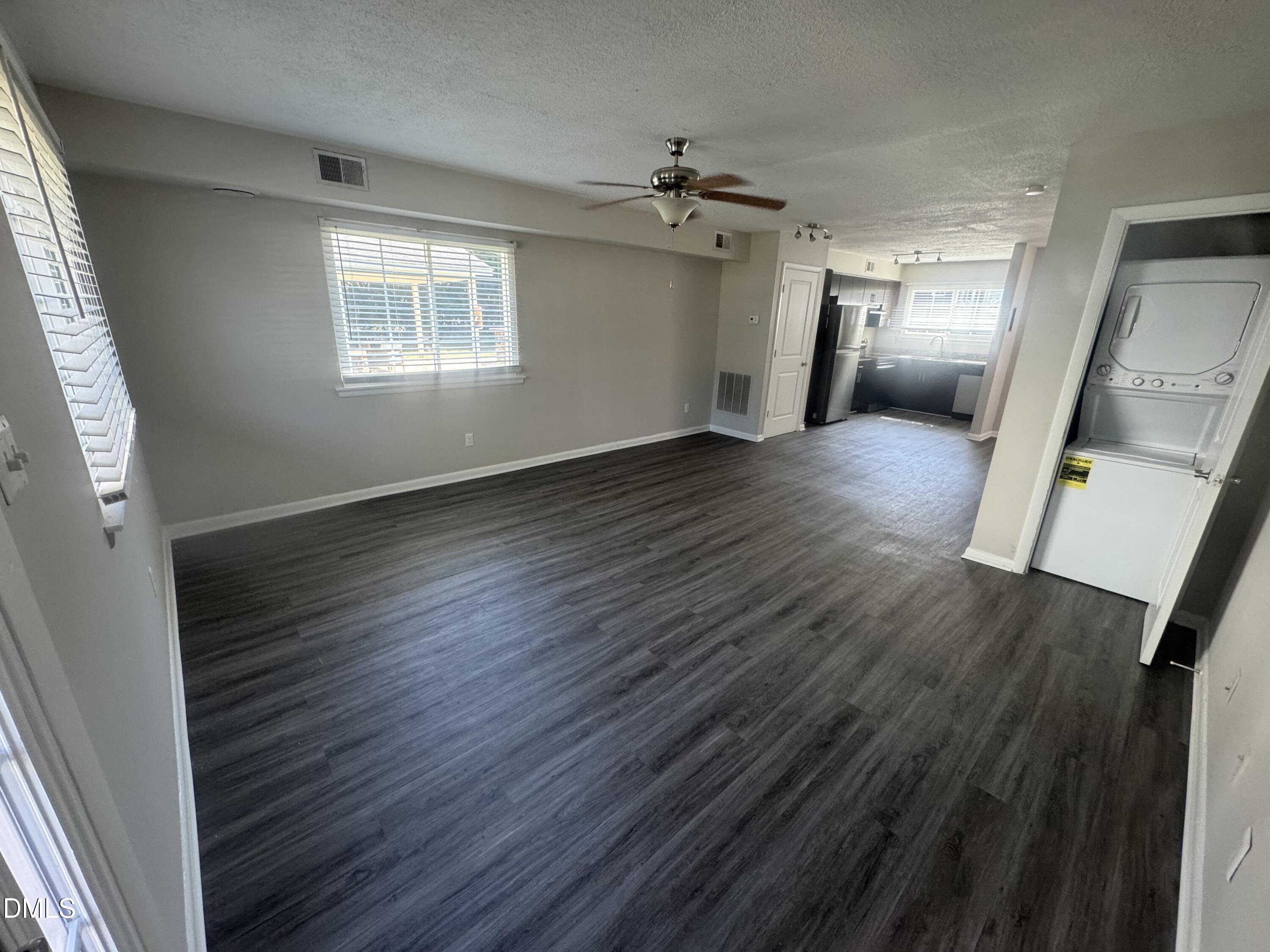 2604 Noble Road, Unit C Raleigh, NC 27608 - Photo 7 of 7 an empty room with wooden floor and windows