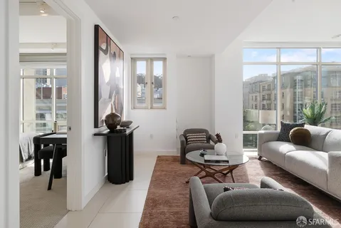 a living room with furniture and a floor to ceiling window