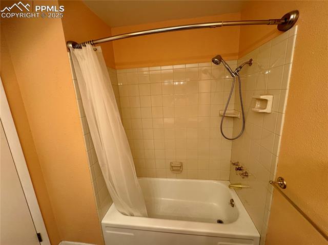 280 Raven Hills Road Colorado Springs, CO 80919 - Photo 34 of 48 Full bath featuring shower / tub combo with curtain and a textured wall