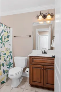 a bathroom with a toilet a sink and a mirror