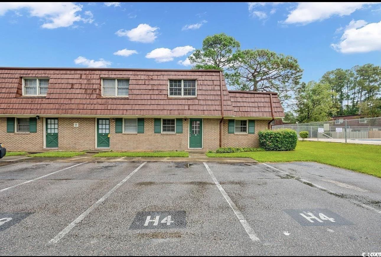 1025 Carolina Road, Unit H4 Conway, SC 29526 - Photo 1 of 10 Multi unit property featuring brick siding, uncovered parking, and mansard roof