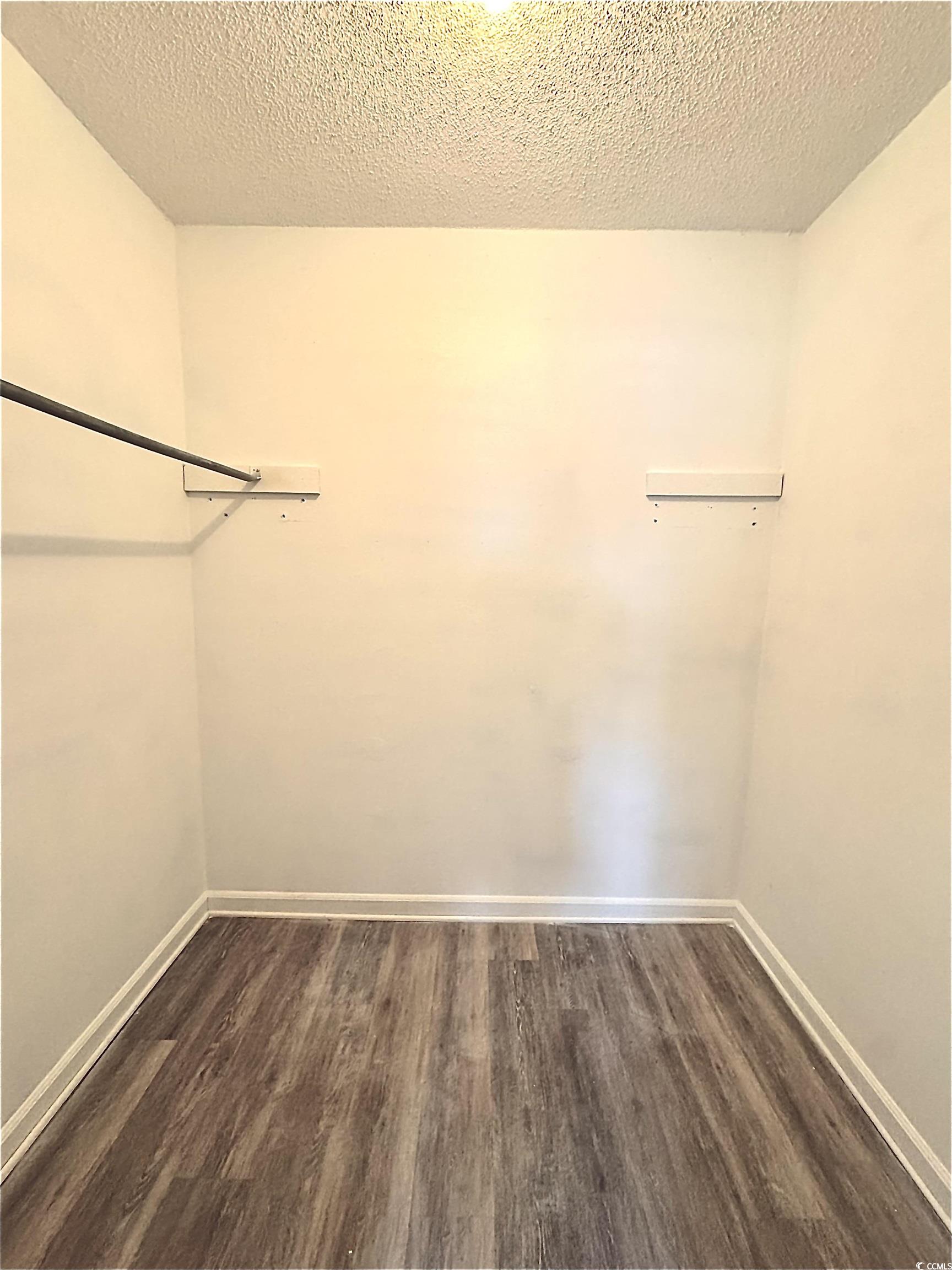 1025 Carolina Road, Unit H4 Conway, SC 29526 - Photo 6 of 10 Walk in closet featuring dark wood-type flooring