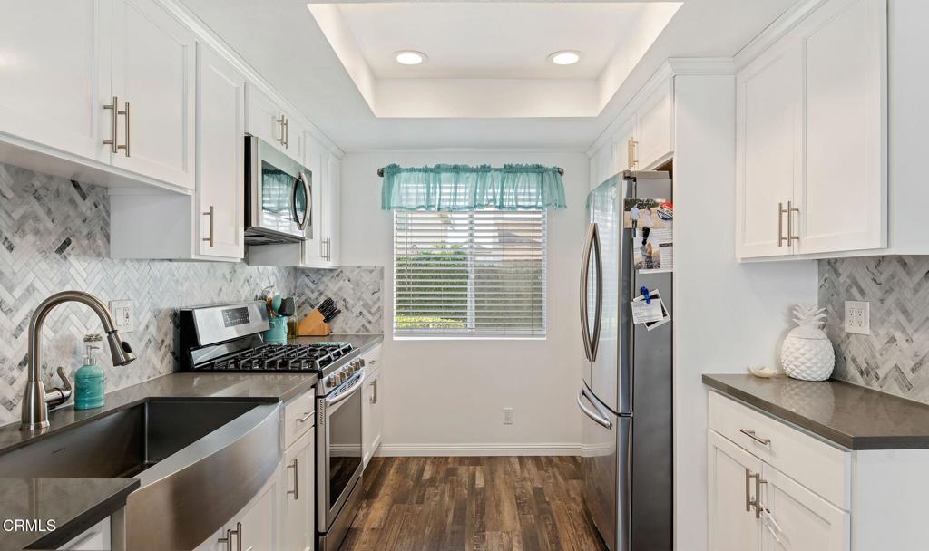 3175 Kelp Lane Oxnard, CA 93035 - Photo 6 of 15 a kitchen with granite countertop a sink a counter space and cabinets