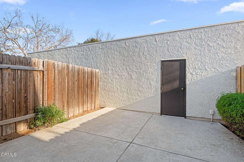 3175 Kelp Lane Oxnard, CA 93035 - Photo 7 of 15 a view of backyard with potted plants and wooden fence