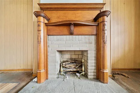 a living room with a furniture and a fireplace