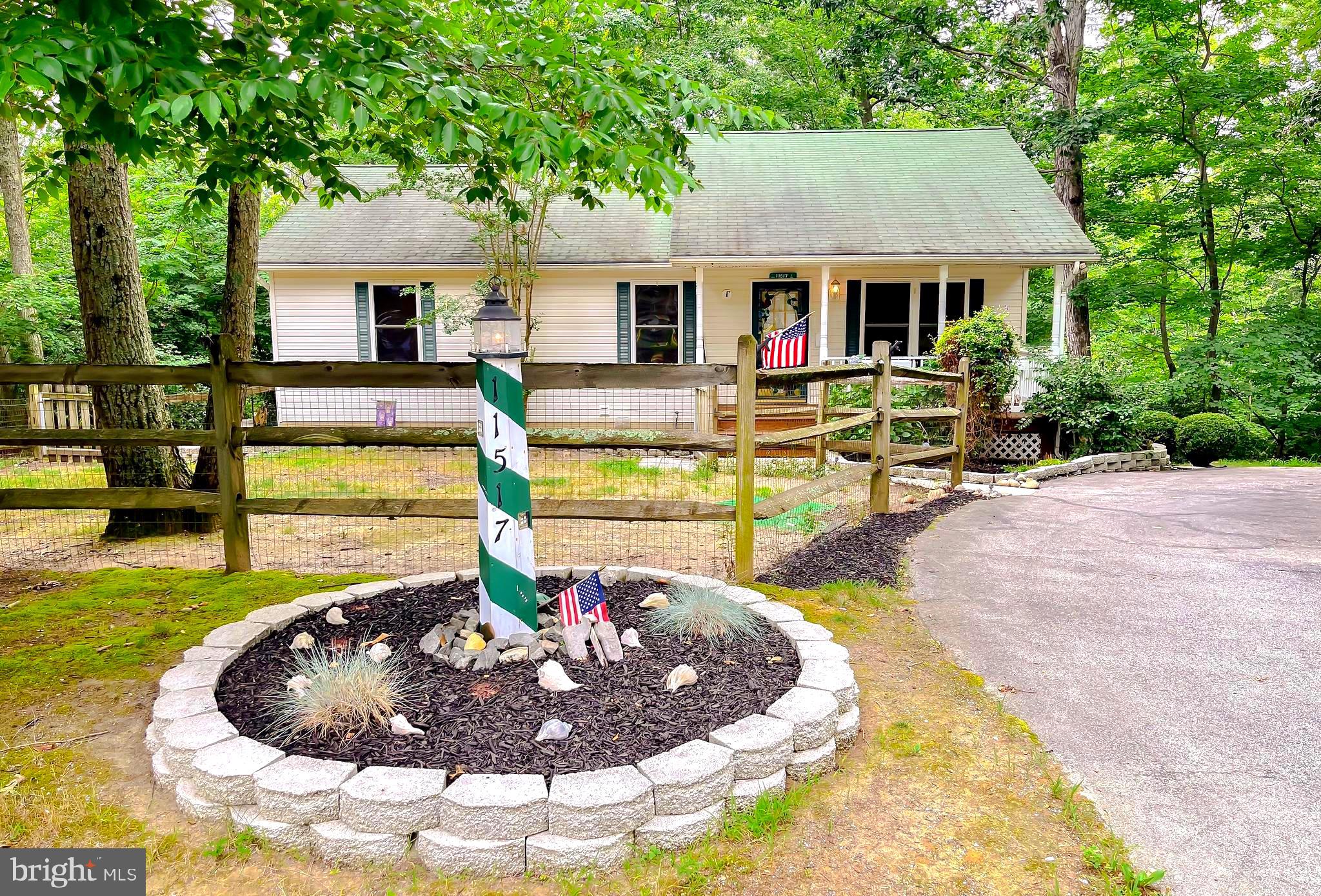 11517 Wrangler Road Lusby, MD 20657 - Photo 1 of 52 a view of a house with swimming pool and a small yard