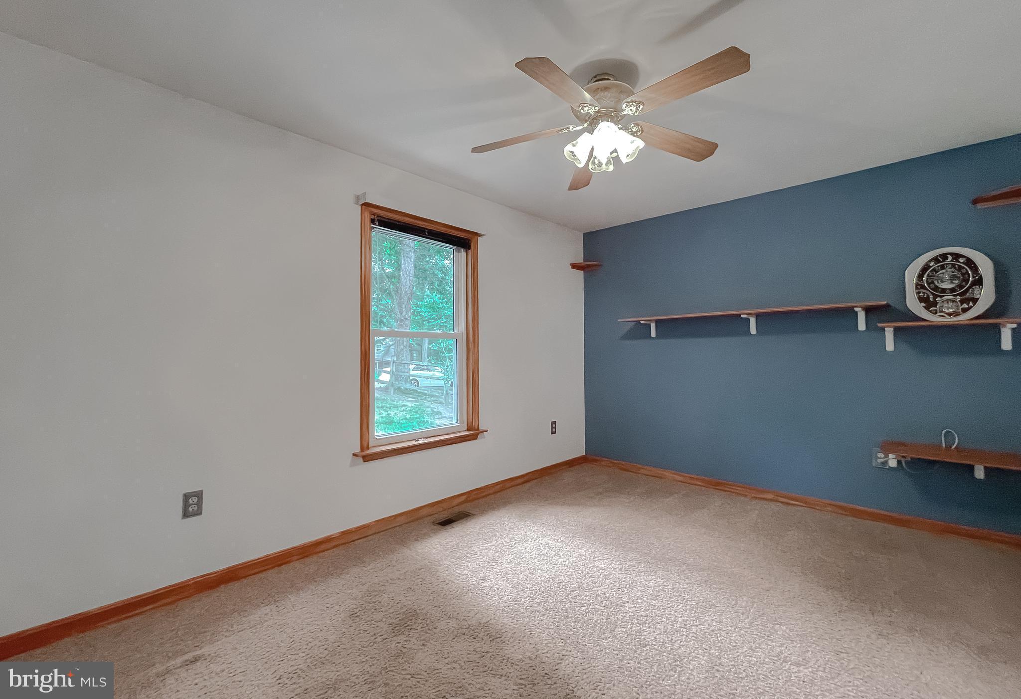 11517 Wrangler Road Lusby, MD 20657 - Photo 17 of 52 an empty room with windows and fan