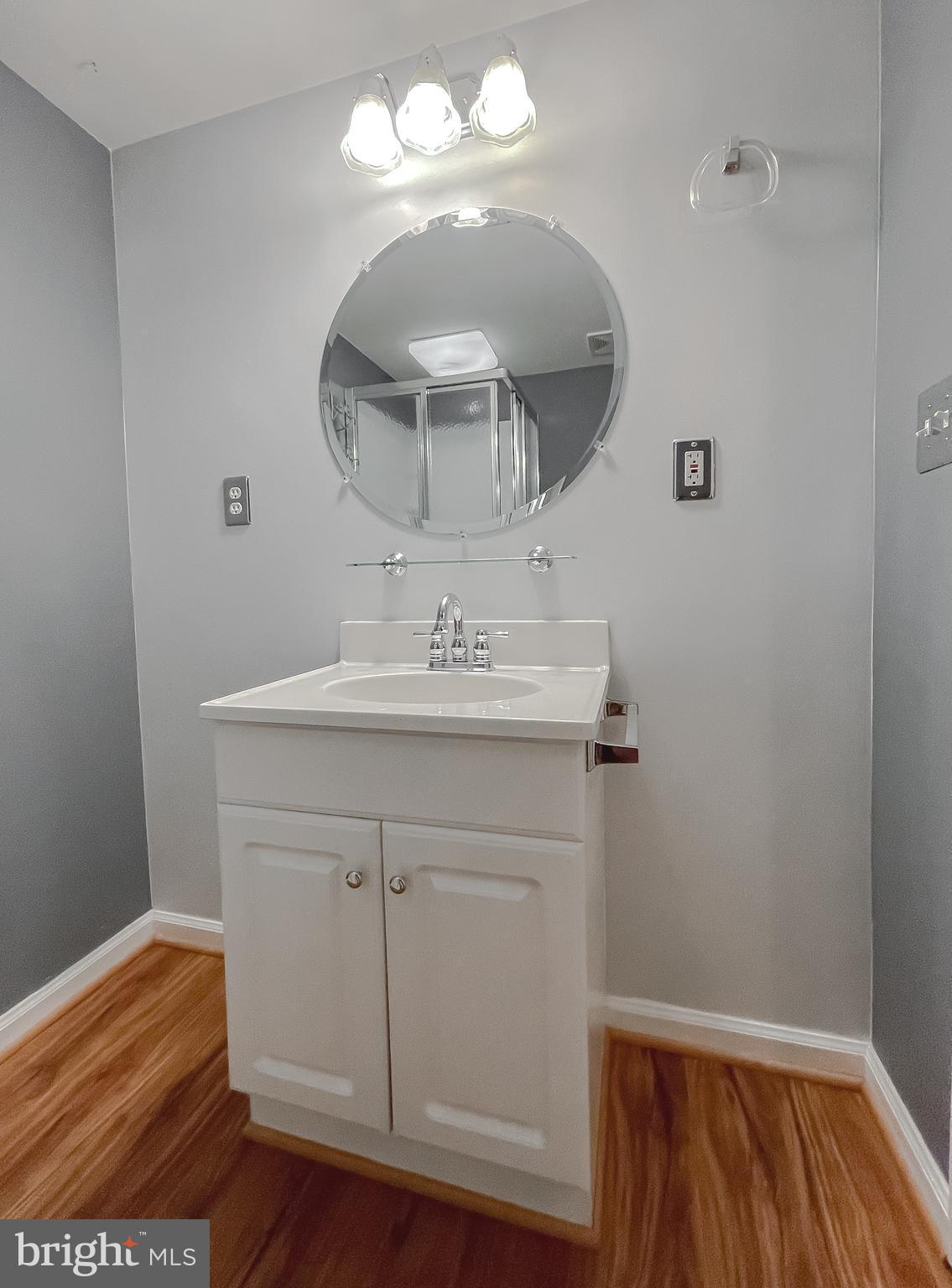 11517 Wrangler Road Lusby, MD 20657 - Photo 35 of 52 a bathroom with a sink and a mirror