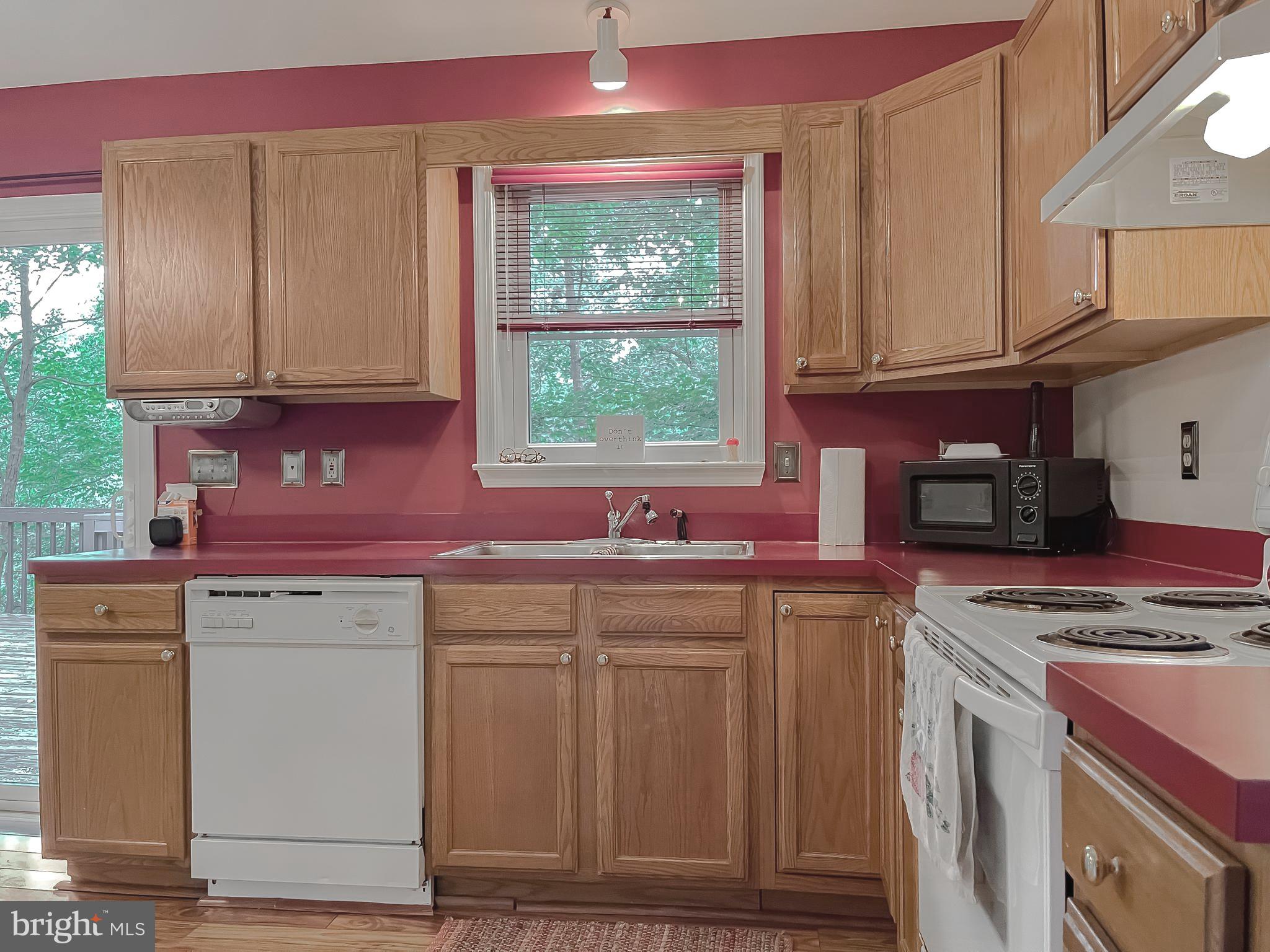 11517 Wrangler Road Lusby, MD 20657 - Photo 5 of 52 a kitchen with stainless steel appliances granite countertop a stove a sink and a microwave