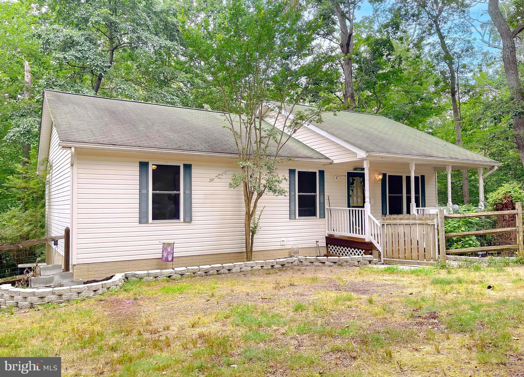 11517 Wrangler Road Lusby, MD 20657 - Photo 52 of 52 a front view of house with yard outdoor seating and barbeque oven