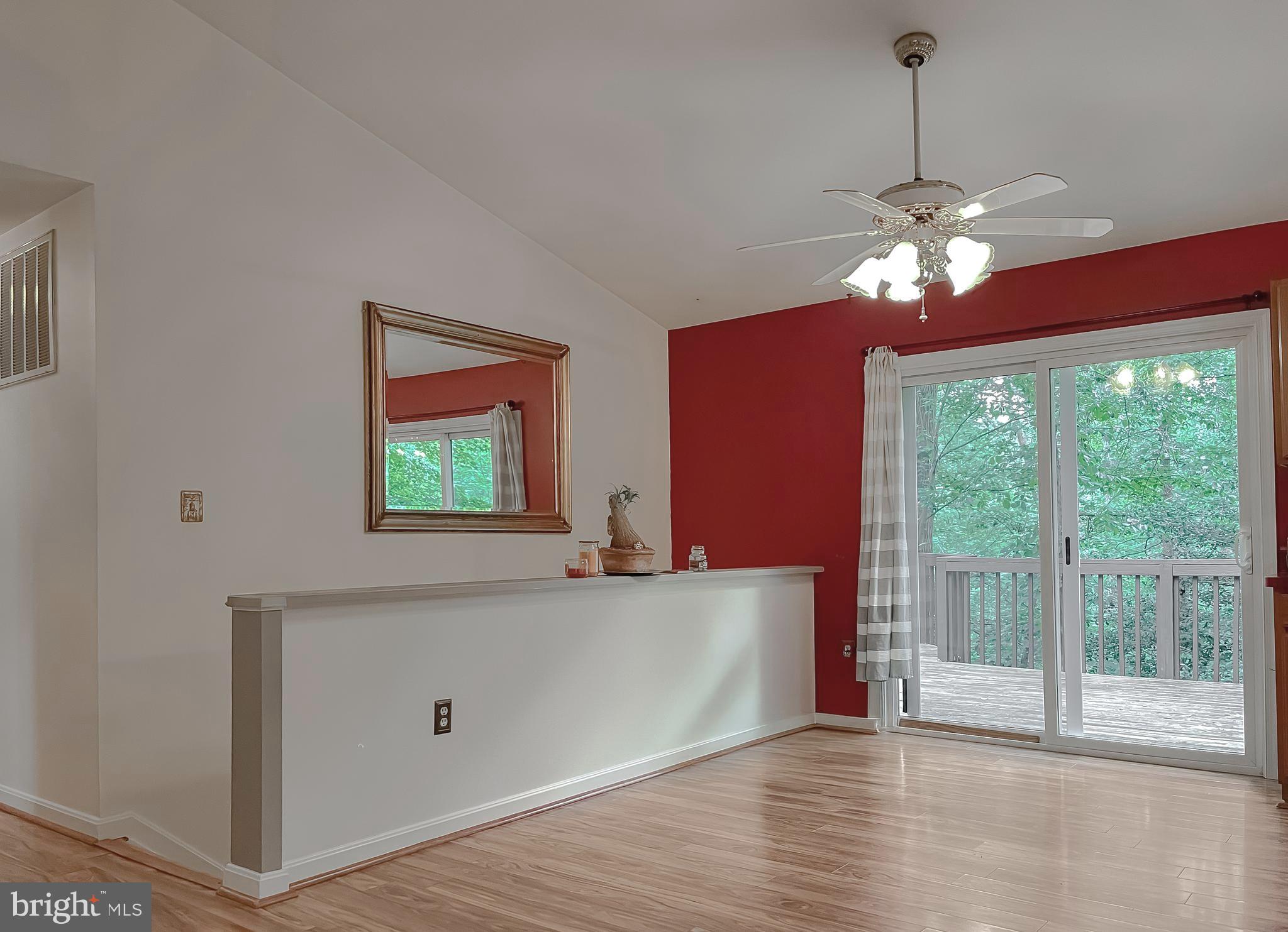 11517 Wrangler Road Lusby, MD 20657 - Photo 7 of 52 a view of a livingroom with a chandelier fan and a large window