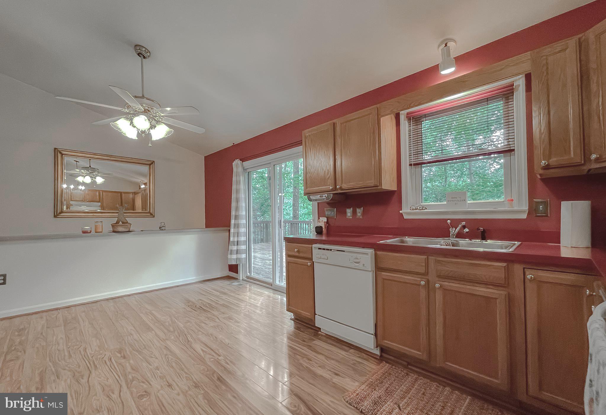 11517 Wrangler Road Lusby, MD 20657 - Photo 8 of 52 a kitchen with stainless steel appliances granite countertop a sink a stove and refrigerator