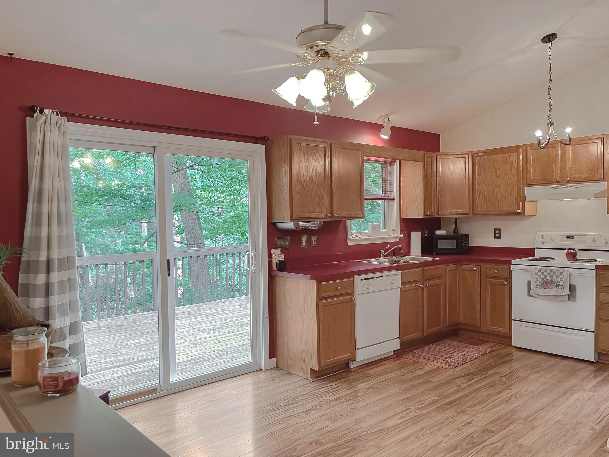 11517 Wrangler Road Lusby, MD 20657 - Photo 9 of 52 a kitchen with stainless steel appliances granite countertop a stove a sink and a refrigerator