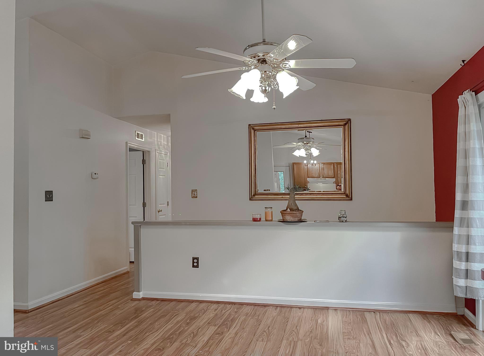 11517 Wrangler Road Lusby, MD 20657 - Photo 10 of 52 a view of a room with wooden floor and chandelier