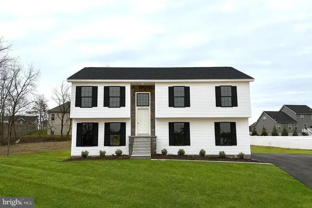a big house with a big yard and large trees
