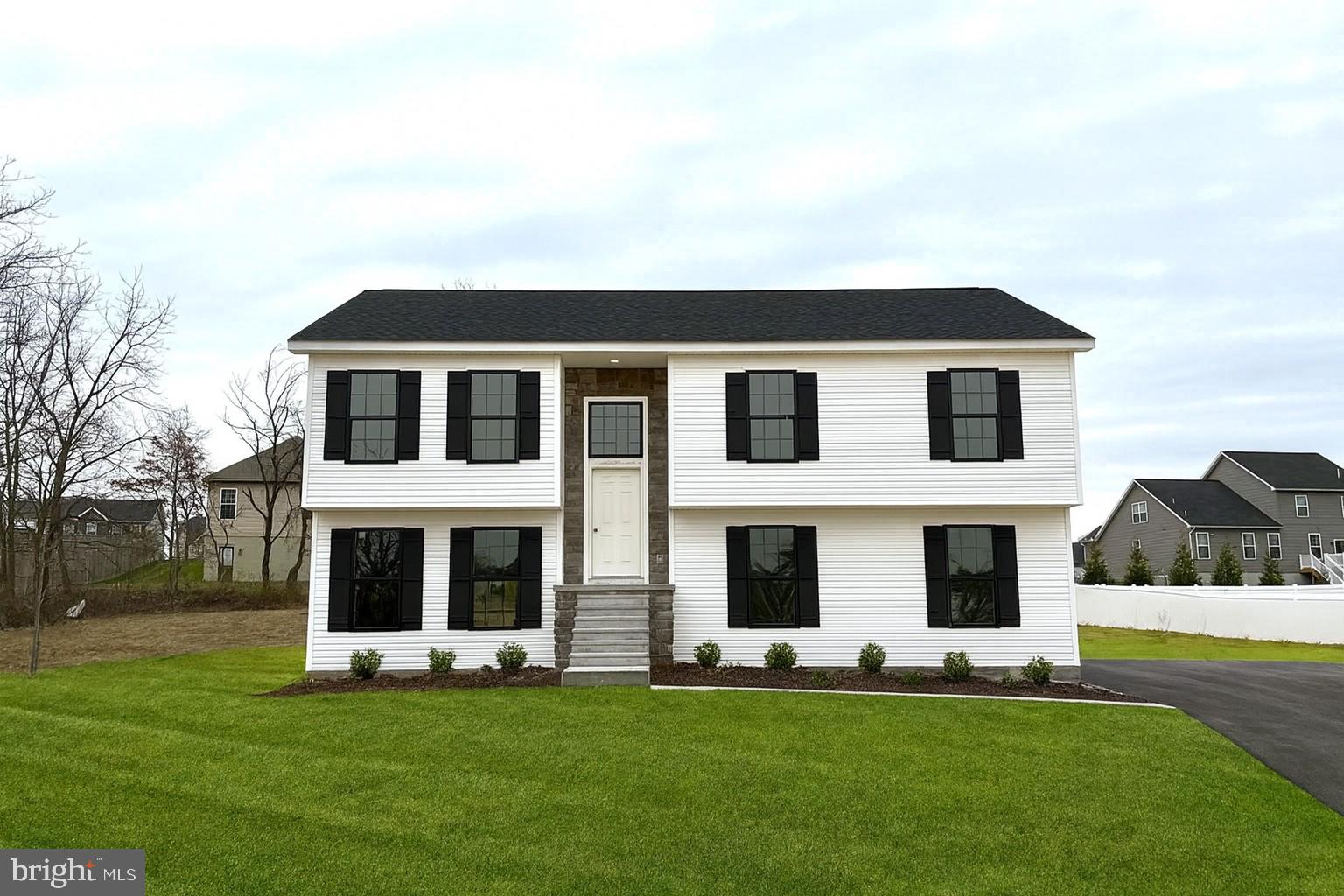 a big house with a big yard and large trees