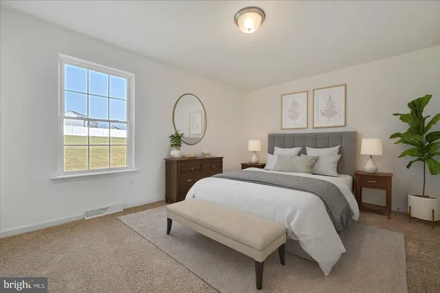 a bedroom with a bed a potted plant and a window