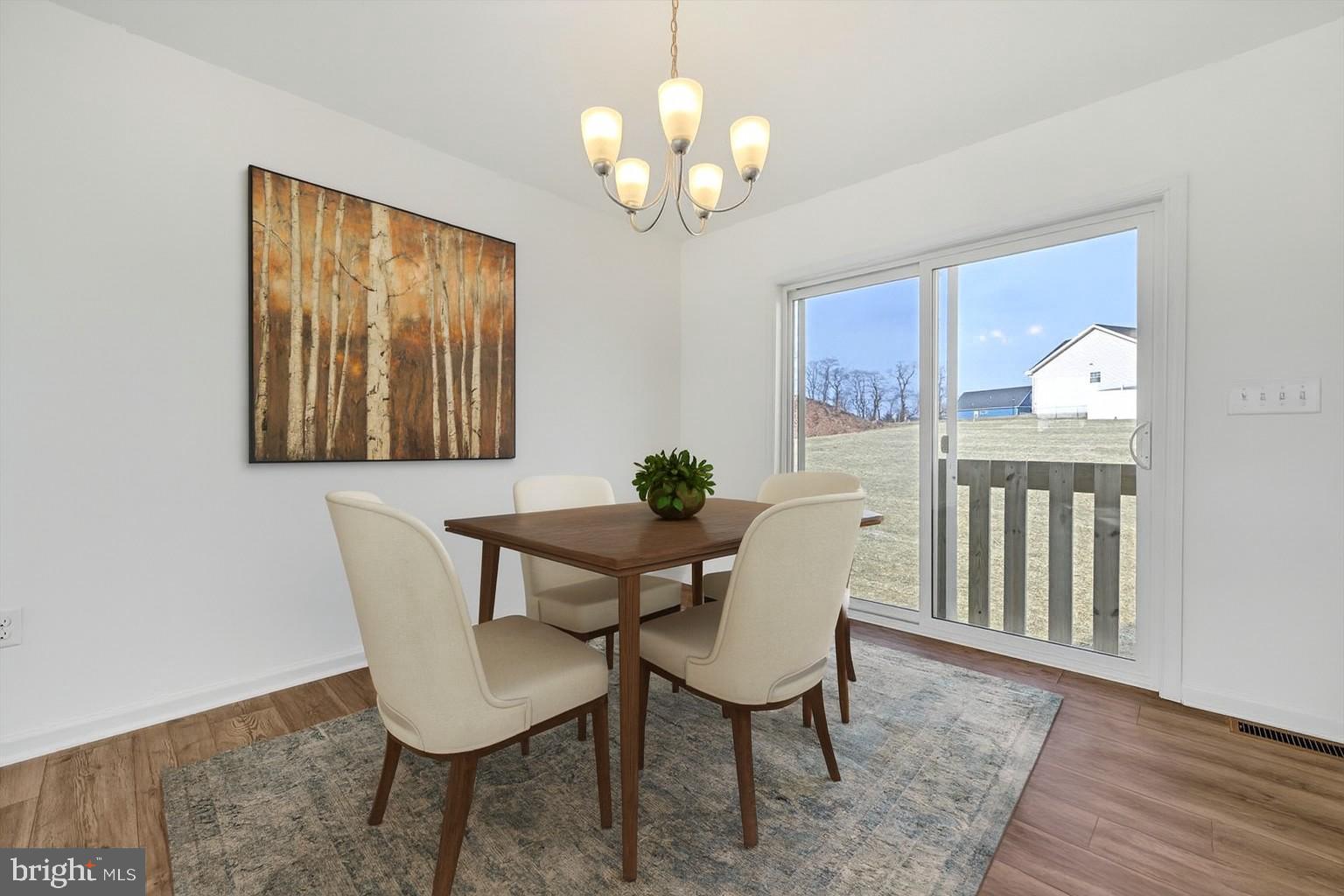 1280 Maple Lane, Unit 10 Hanover, PA 17331 - Photo 9 of 20 a view of a dining room with furniture window and wooden floor