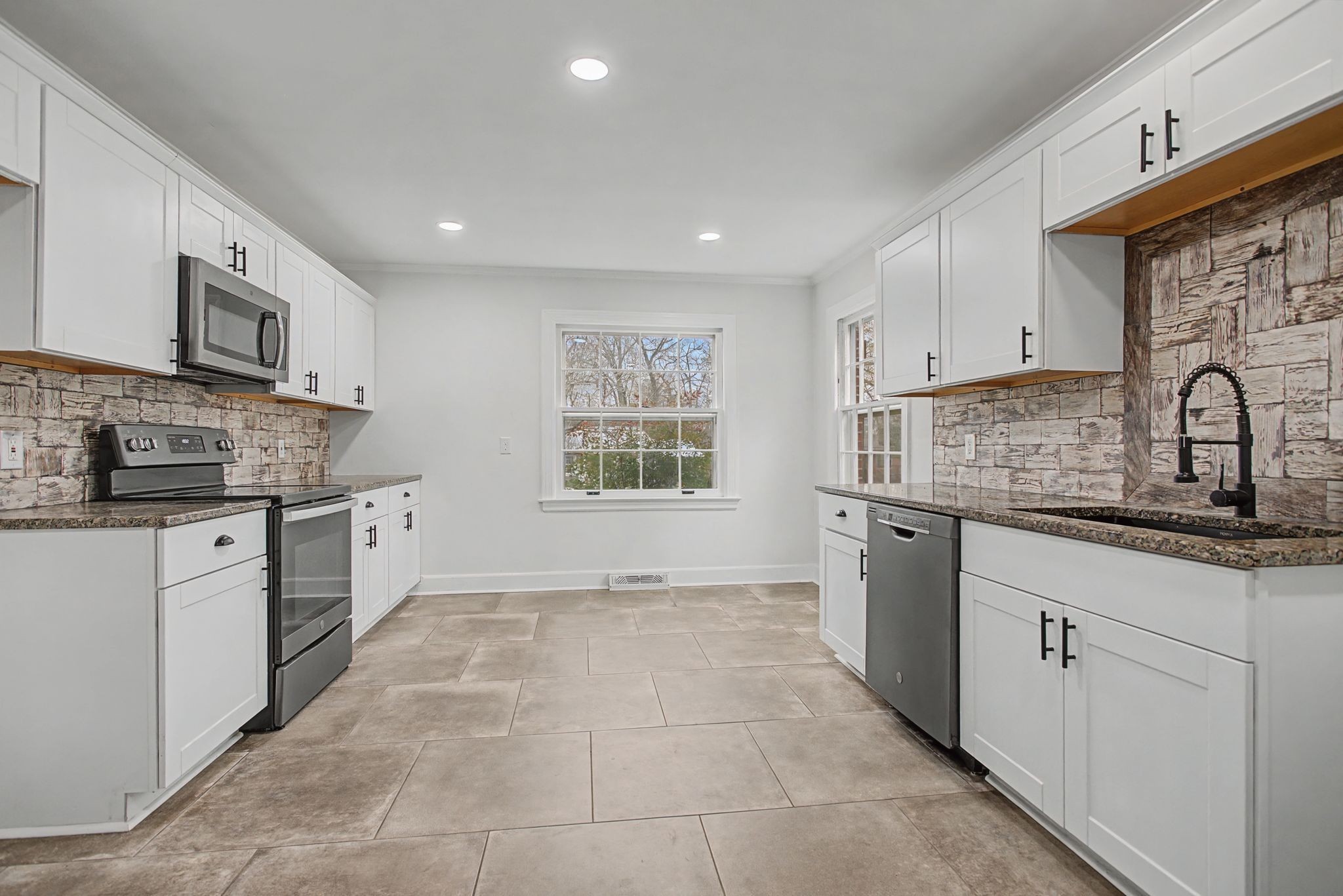 107 Cherry Street Centerville, TN 37033 - Photo 11 of 33 a kitchen with a sink stove and cabinets