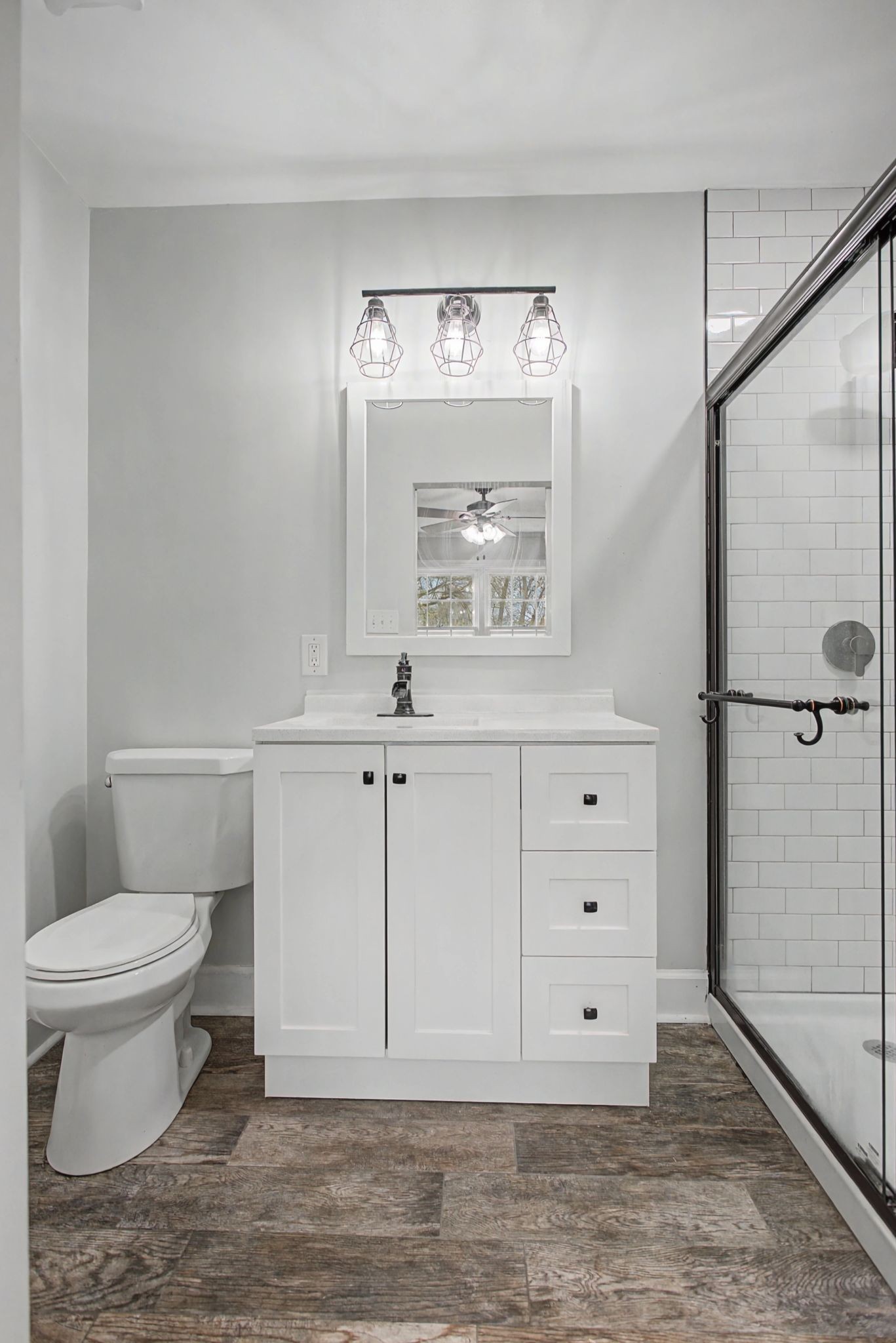 107 Cherry Street Centerville, TN 37033 - Photo 24 of 33 a bathroom with a toilet a sink a vanity and mirror