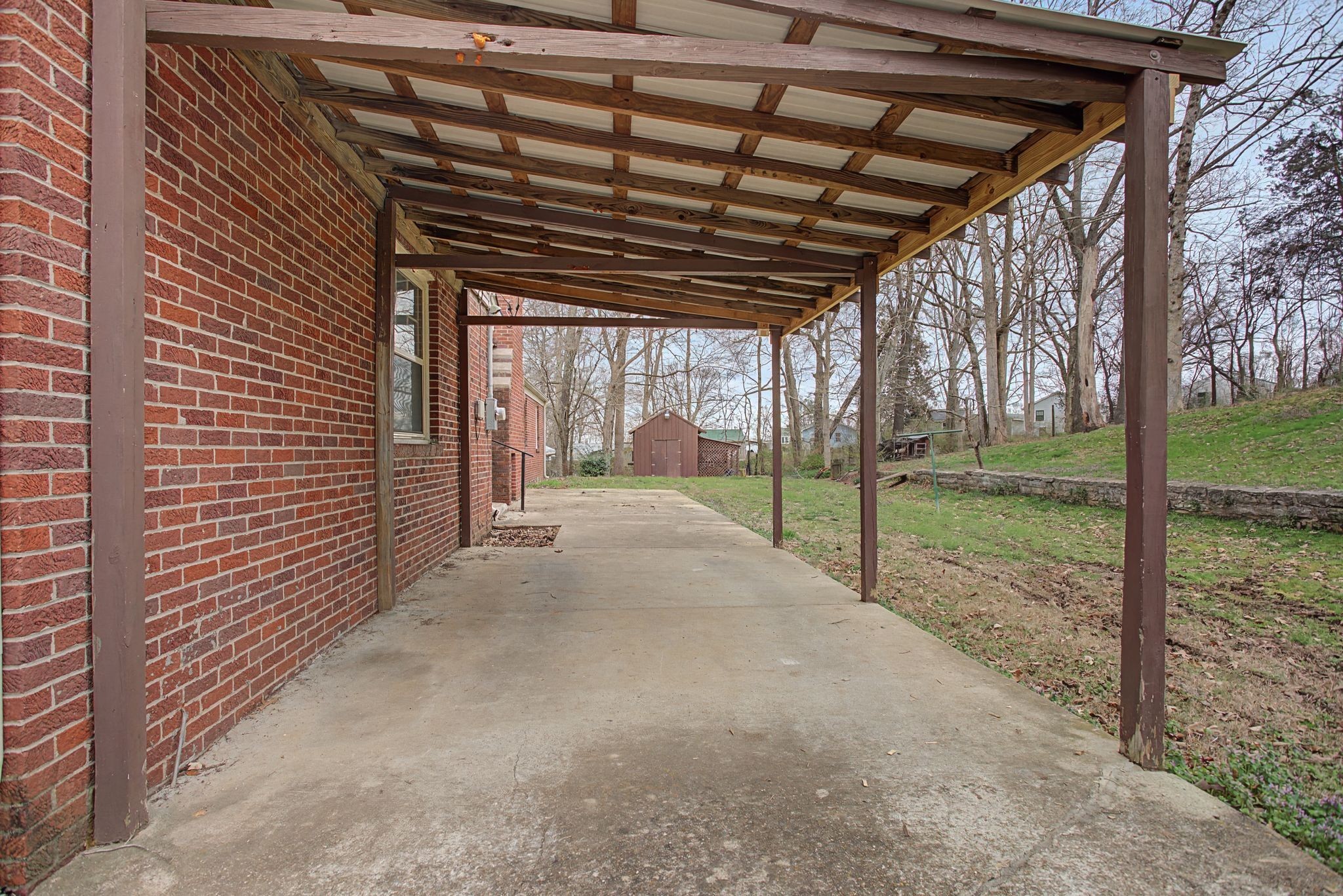 107 Cherry Street Centerville, TN 37033 - Photo 29 of 33 a view of a porch with wooden floor and roof with a garden