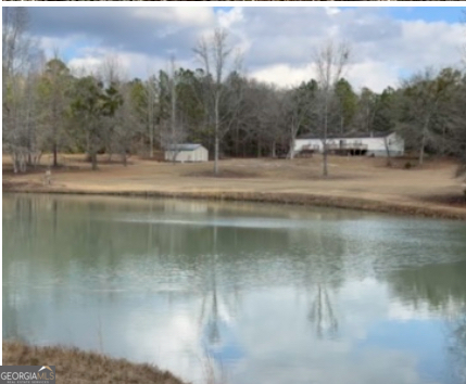 a view of a water pond with green space