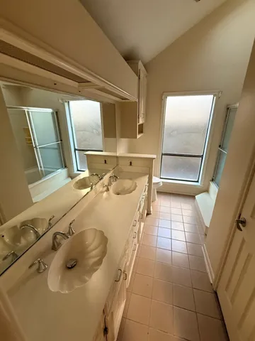 a bathroom with a sink a toilet and mirror