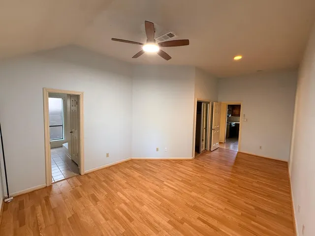 a view of a livingroom with a ceiling fan and window