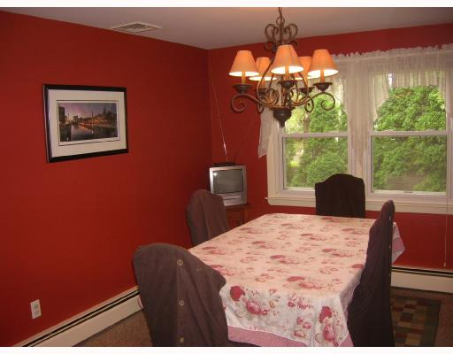 84 Linden Road Seekonk, MA 02771 - Photo 4 of 6 a bedroom with a bed and a chandelier