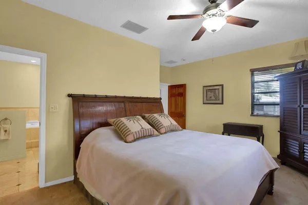 a bathroom with a granite countertop tub a sink and a large mirror